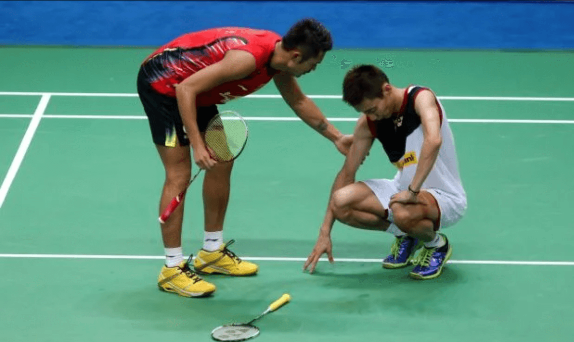 What is the act of carrying in badminton?
